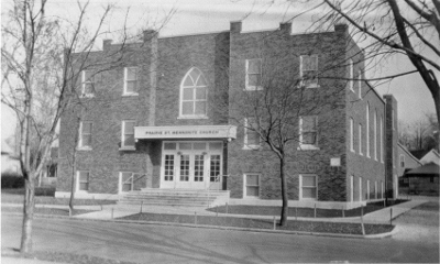 A black and white photo of the brick front of of the church in 1932.